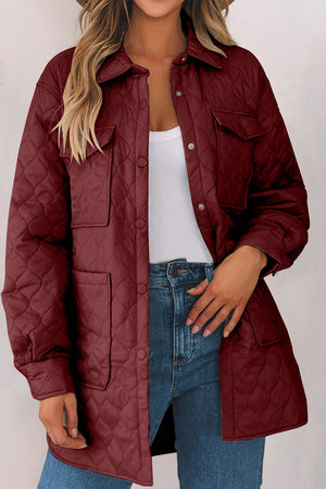 Burgundy quilted utility jacket with snap buttons and chest pockets.