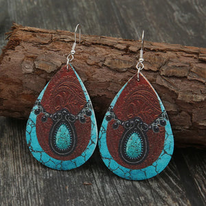 Cowhide teardrop earrings with turquoise and brown western pattern.