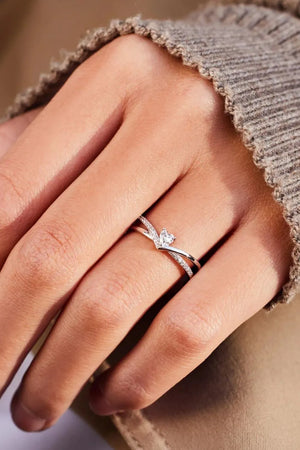 Silver V-shaped ring with diamond accents and a wishbone design.