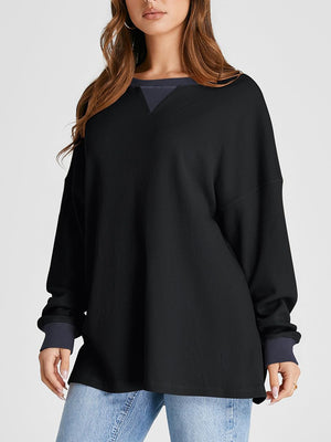 Black waffle knit raglan sleeve sweatshirt with contrast neckline and cuffs.