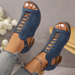 Navy blue criss-cross cut-out block heel sandals with adjustable ankle strap.