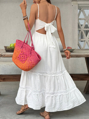 White lace tiered maxi dress with spaghetti straps and a back tie bow detail.