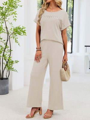 Beige lace cutout waffle knit two-piece set with wide leg pants and short sleeve top.
