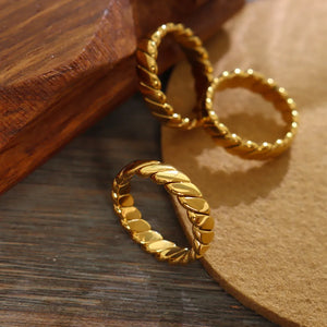 Gold braided titanium band ring with twisted detail
