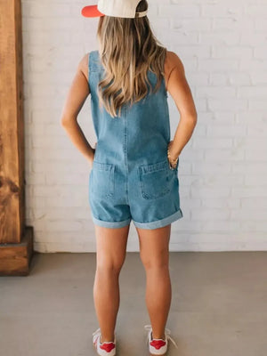 Denim romper with cuffed shorts, back pockets, and zipper closure.