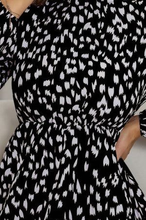 Black dotted print mini dress with gathered waist and long sleeves