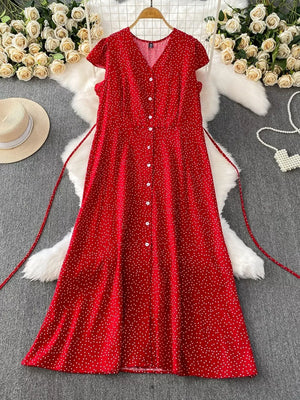 Red polka dot maxi dress with V-neck, short sleeves, button front, and belt.