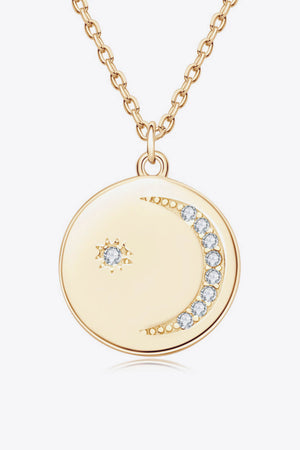 Gold pendant necklace with celestial moon and star charms, accented with crystals.