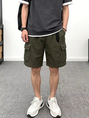 Men's green cotton cargo shorts with multiple pockets and a black belt.