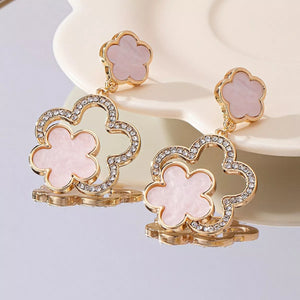 18K gold-plated dangle earrings with pink clover charms and crystal accents.