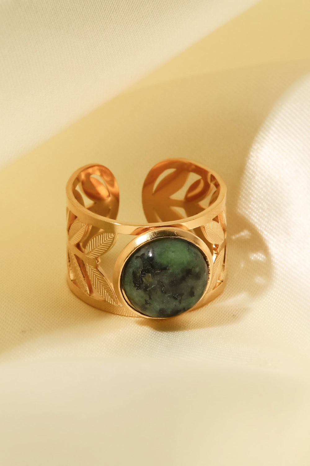 Gold ring with leaf cutouts and a malachite stone