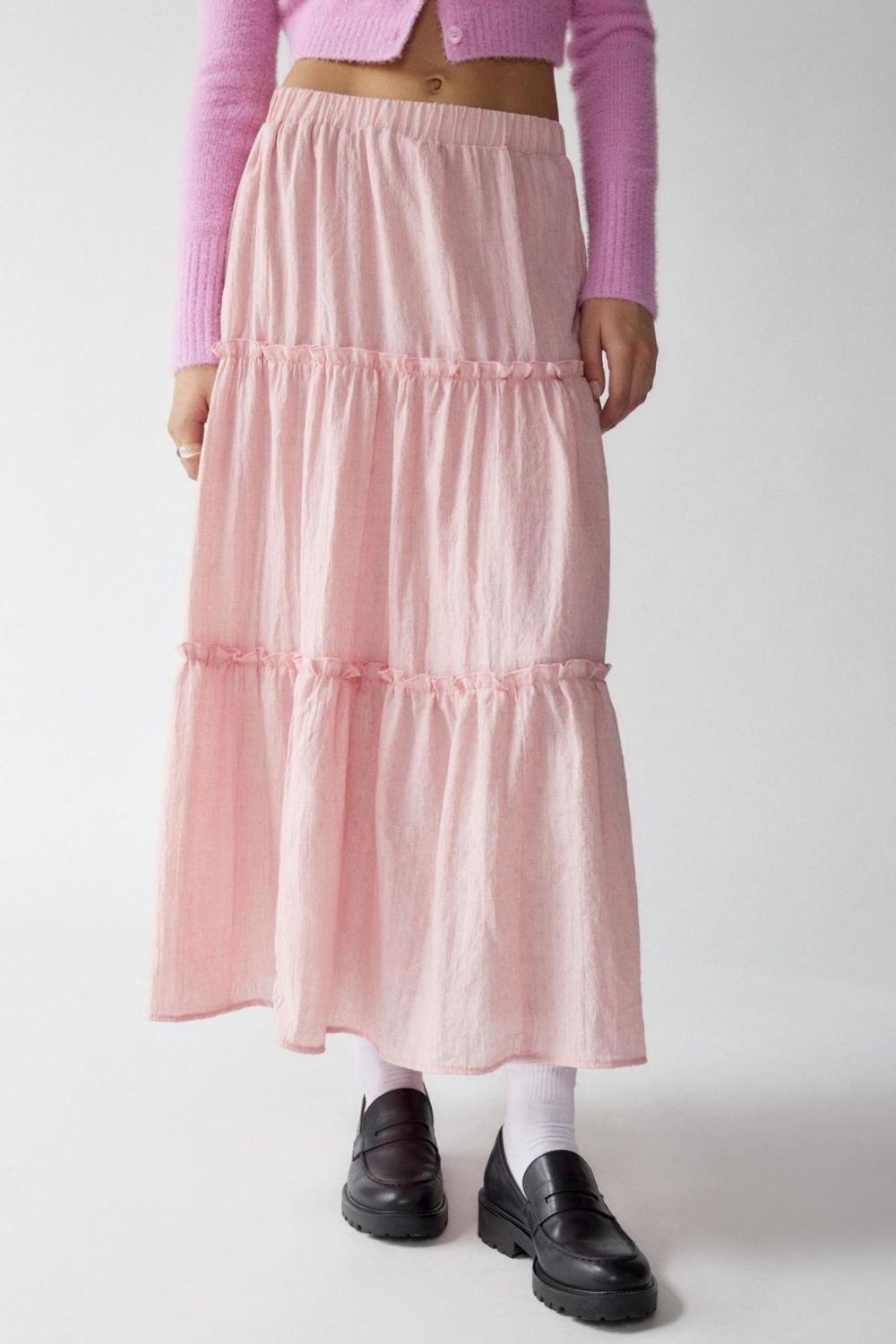 Tiered cotton maxi skirt in blush pink with ruffled tiers and an elastic waistband.