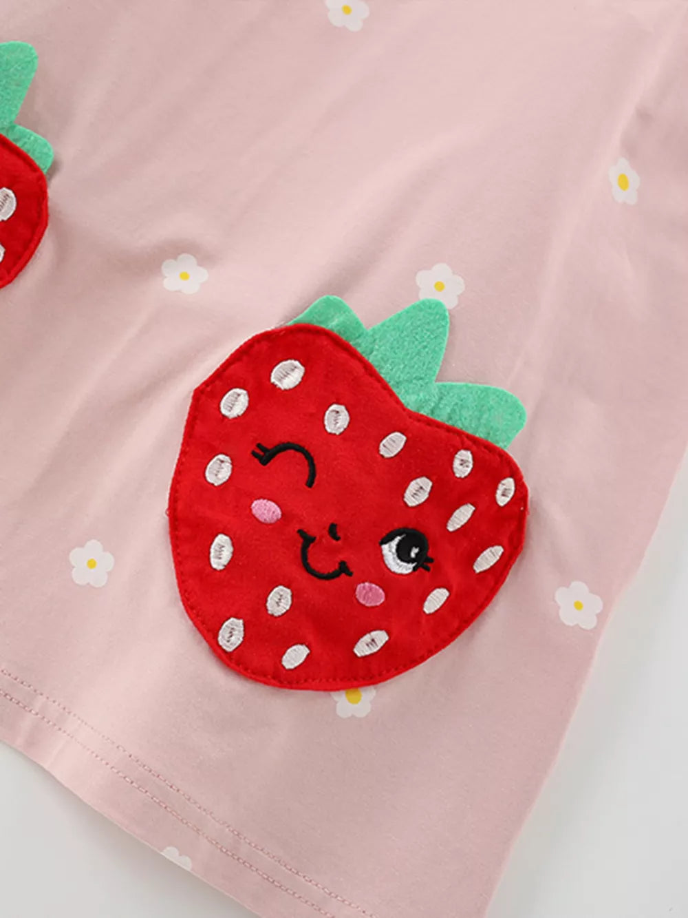 Pink cotton baby dress with playful strawberry applique and floral print.
