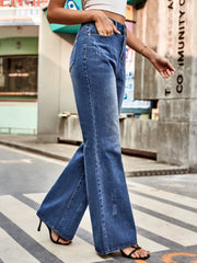 Dark blue denim flare jeans with distressed details and a high waist.