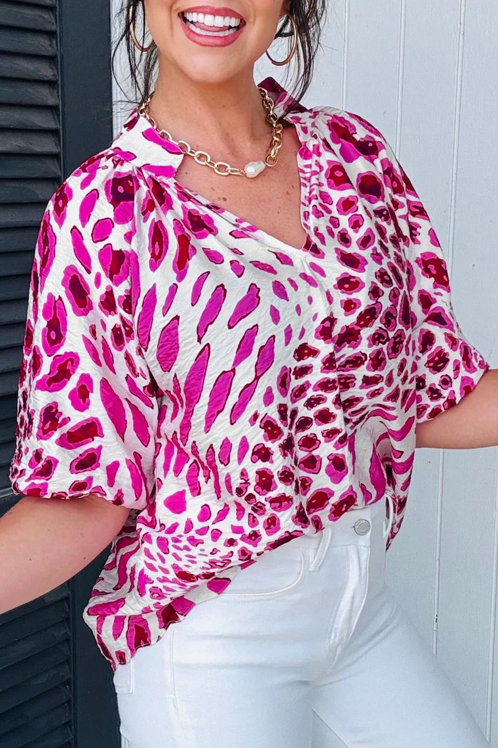 Vibrant leopard print V-neck blouse with short sleeves and a relaxed fit.