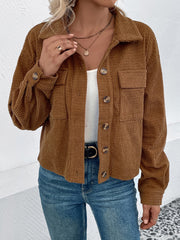 Textured corduroy cropped shirt jacket in camel with button front and chest pockets.