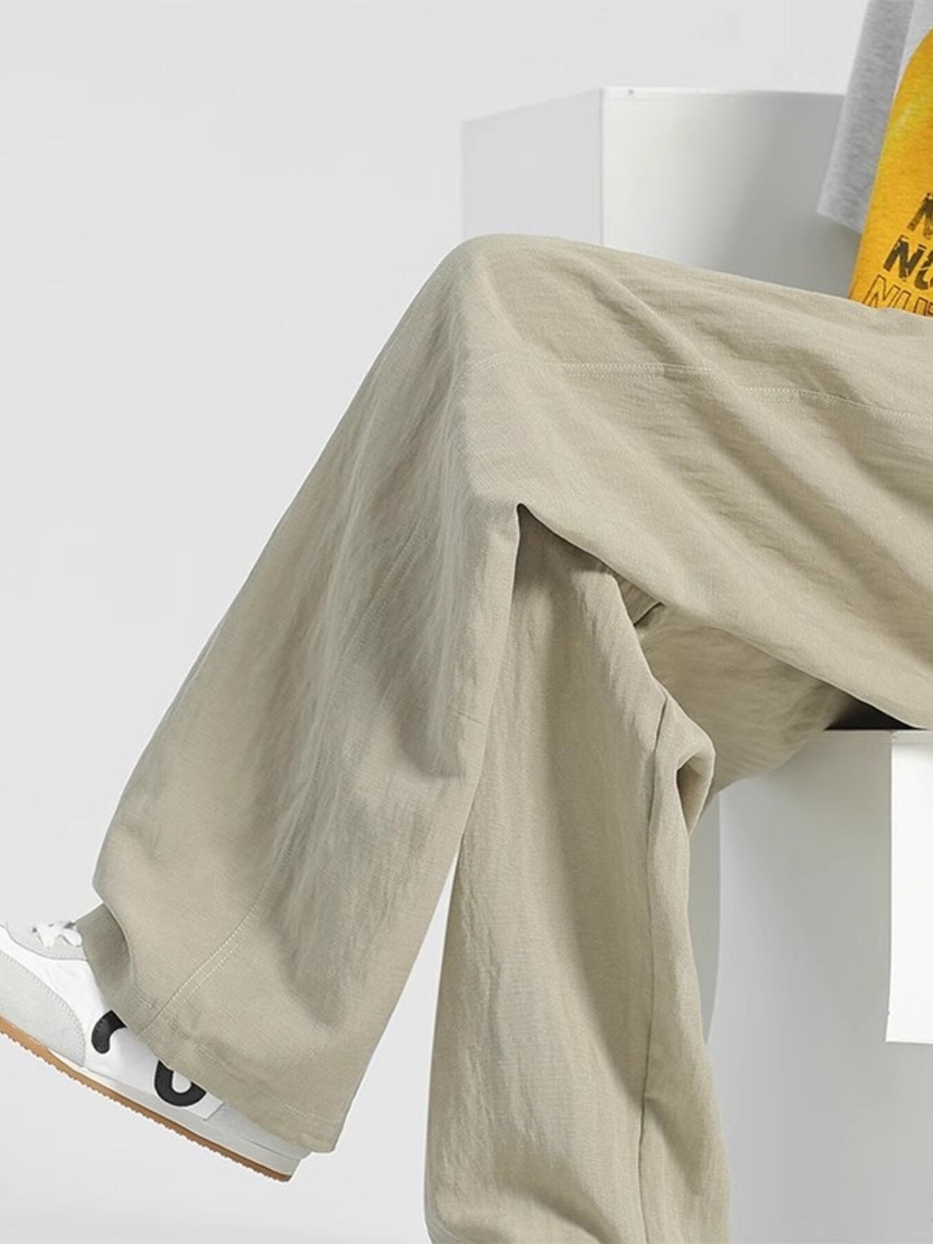 Men's beige relaxed fit sweatpants with a comfortable, casual style.
