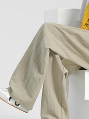Men's beige relaxed fit sweatpants with a comfortable, casual style.