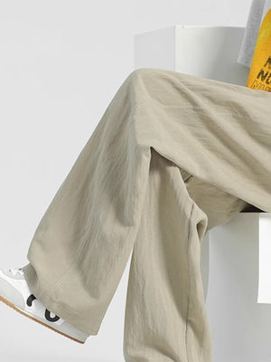 Men's beige relaxed fit sweatpants with a comfortable, casual style.