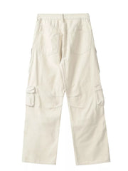 Cream cargo pants with buttoned multi-pocket design and wide leg cut.