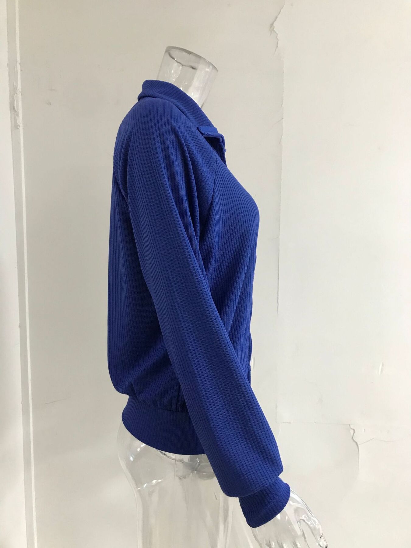 Blue ribbed knit plus size trench coat with collar and long sleeves.