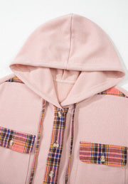Blush pink waffle knit shacket with plaid trim on pockets and placket, featuring a hood.