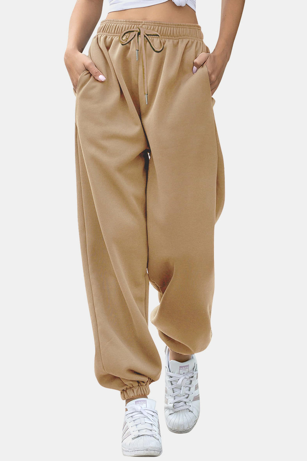 Tan relaxed-fit cuffed sweatpants with drawstring and pockets.