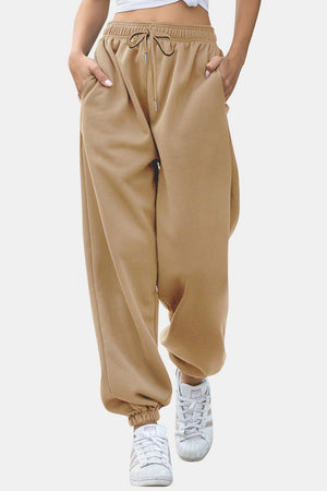 Tan relaxed-fit cuffed sweatpants with drawstring and pockets.