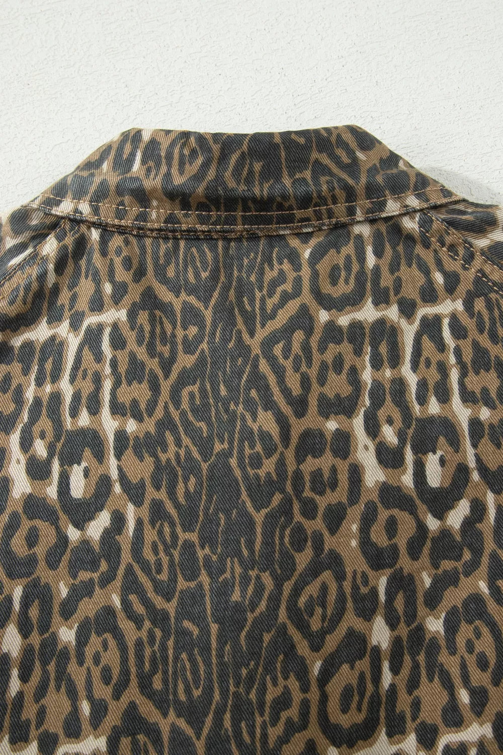 Denim dress with leopard print and puff sleeves, featuring a collar detail.