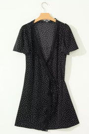 Black polka dot wrap mini dress with lace trim and flutter sleeves.