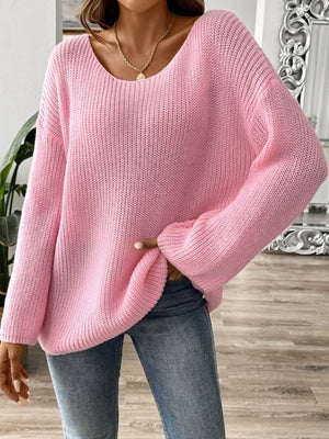Dusty pink ribbed knit pullover sweater with off-the-shoulder neckline and long sleeves.
