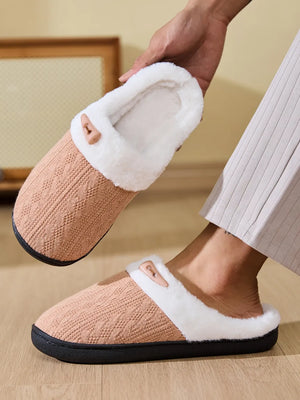 Cable knit house slippers in dusty pink with white shearling lining and a decorative button detail.