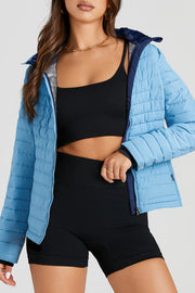 Quilted stand collar puffer jacket in pastel blue with navy trim and faux fur collar lining.