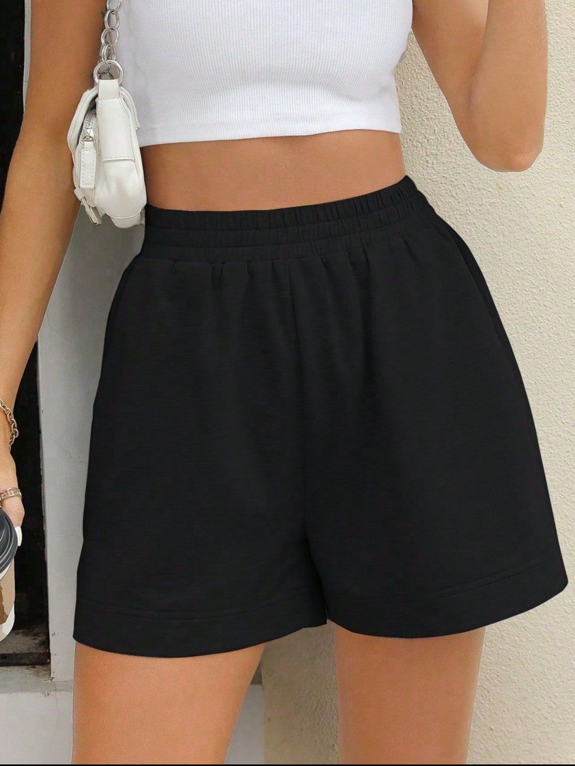 Black relaxed fit sweat shorts with elastic waistband and side pockets
