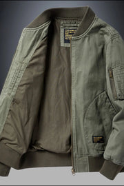 Army green bomber jacket with patch detail and zippered sleeve pocket.