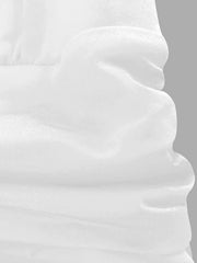 White ruffle hem dress detail showing textured fabric and layered ruffles.