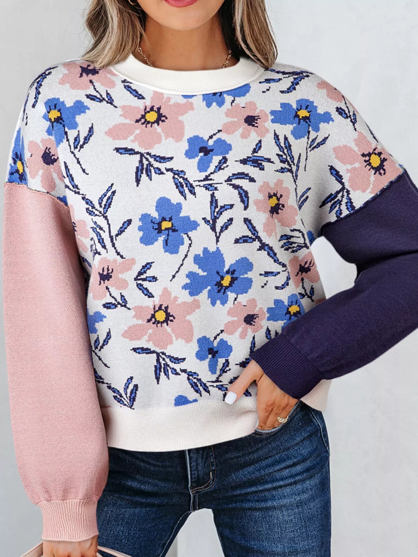 Patchwork floral sweater with crew neck and contrast sleeves in pink and navy.
