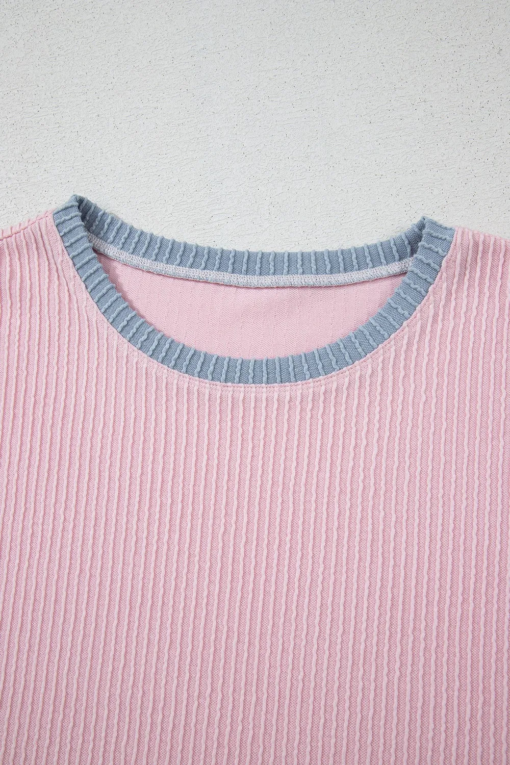 Ribbed blush pink loungewear top with a contrasting grey crewneck collar.