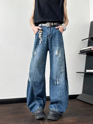 Distressed oversized wide-leg jeans in dark blue denim with ankle length and casual styling.