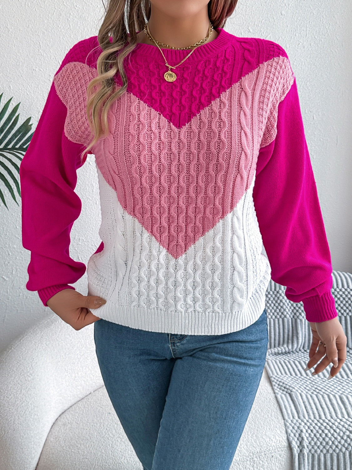 Chevron cable knit sweater with contrast hot pink, light pink, and white panels.