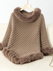 Camel knit poncho with diagonal ribbing and faux fur trim at neckline and hem.