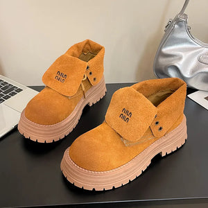 Pumpkin suede fold-over platform boots with embroidered branding and lug sole.