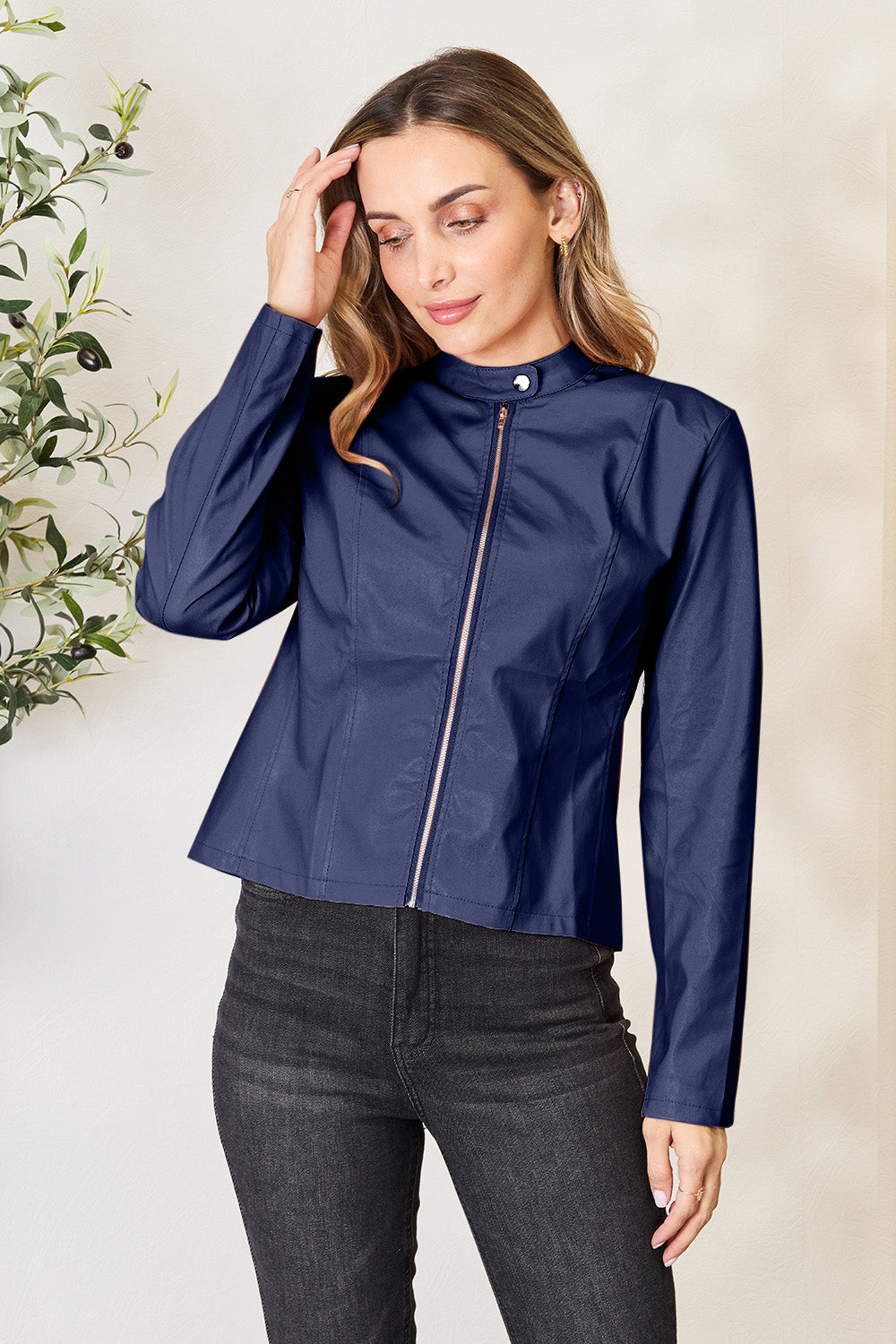 Navy faux leather biker jacket with rose gold zipper and mock neck.