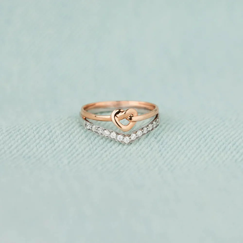 Knot & Chevron Zircon Ring Stack in silver with rose gold heart detail.