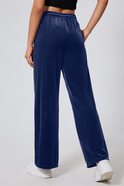 Navy velvet palazzo lounge trousers with a drawstring waist and wide leg.
