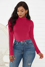 Burgundy turtleneck bodysuit with long sleeves, styled with high-waisted jeans.