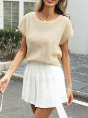 Relaxed openwork knit top in apricot with short sleeves and a crew neck.