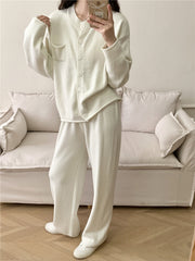 White ribbed knit cardigan and wide leg pants set with button front and pocket detail.