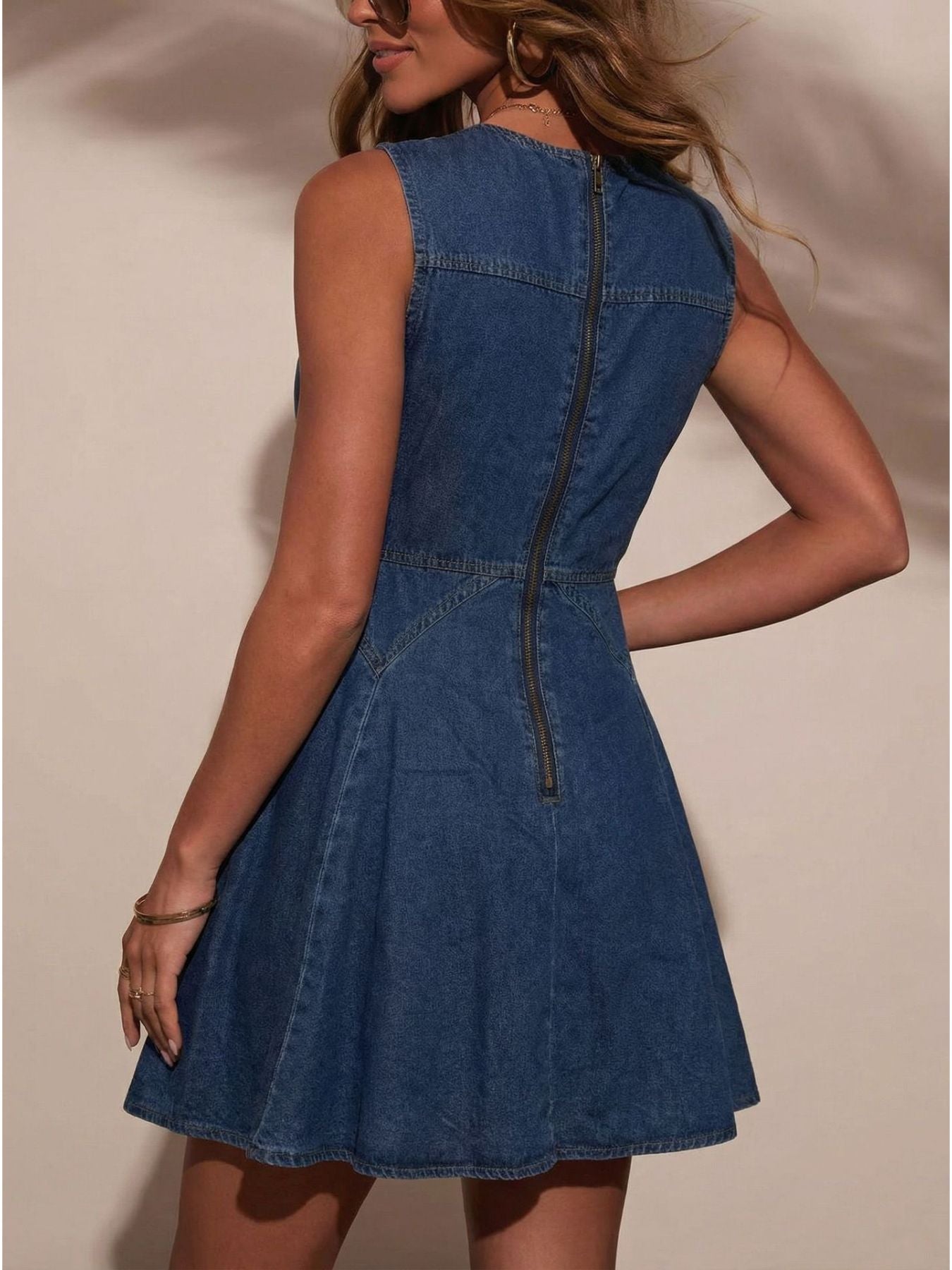 Denim A-line dress with decorative buttons and a back zipper.