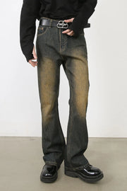 Faded wash bootcut jeans in olive brown with dip dye effect and a relaxed fit.